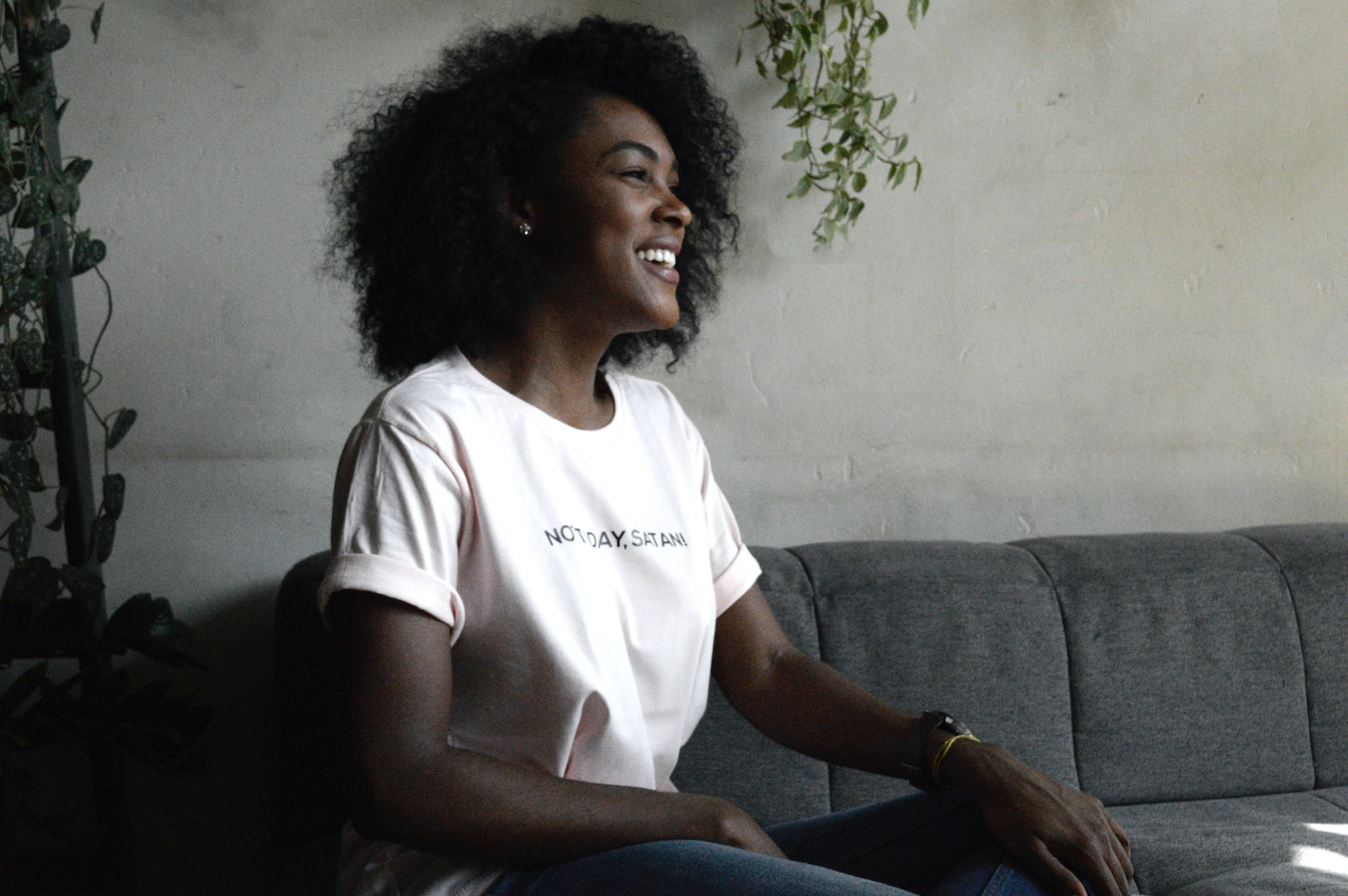 Photo by DISRUPTIVO woman smiling sitting on sofa