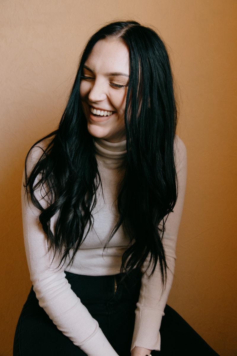 Photo by Sinitta Leunen woman in white long sleeve shirt smiling